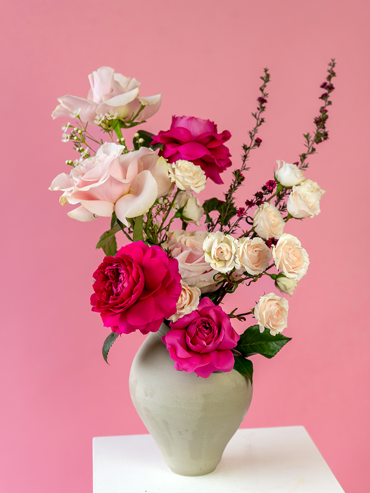 Vancouver Florist - Vancouver Flower Delivery - Valentine's Flowers, Bouquet of pink, white, and red flowers in a gray vase against a pink background