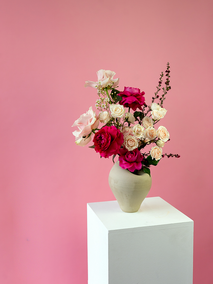 Vancouver Florist - Vancouver Flower Delivery - Valentine's Flowers, Vase of flowers on a white pedestal against a pink background